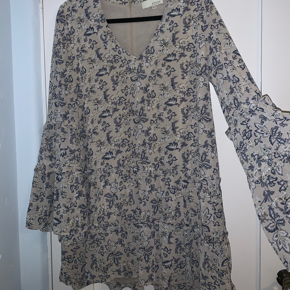 Greg and blue floral dress with plunging neckline